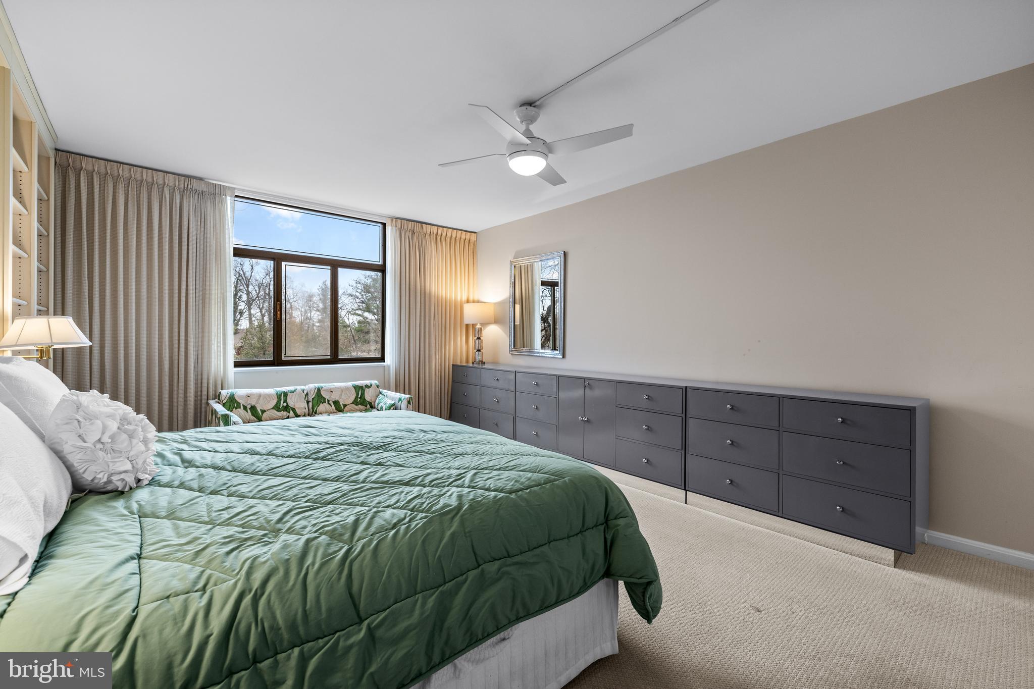 1 Slade Avenue, Unit 304 Baltimore, MD 21208 - Photo 34 of 44 a bedroom with a bed and a dresser