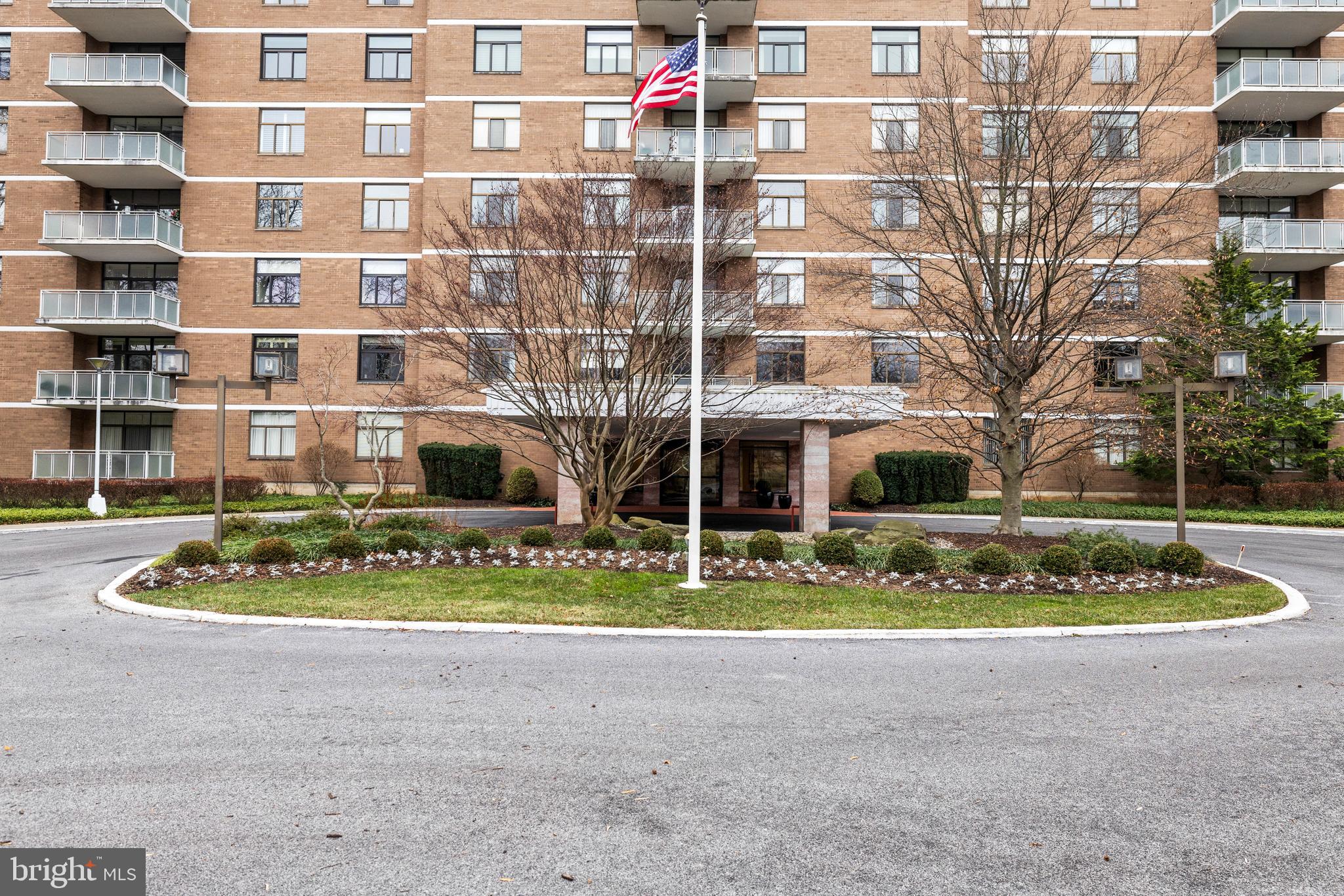 1 Slade Avenue, Unit 304 Baltimore, MD 21208 - Photo 41 of 44 a front view of a residential apartment building with a yard