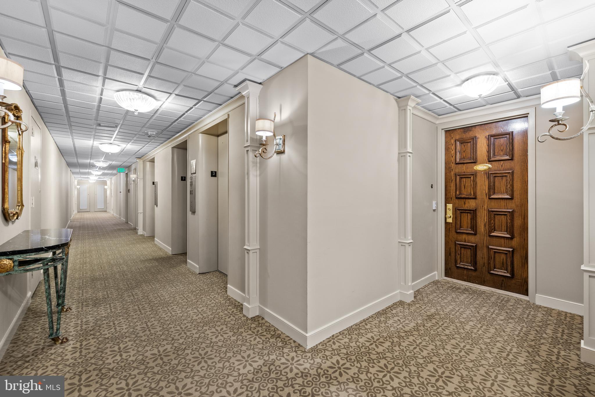 1 Slade Avenue, Unit 304 Baltimore, MD 21208 - Photo 6 of 44 a view of a hallway with wooden shelves