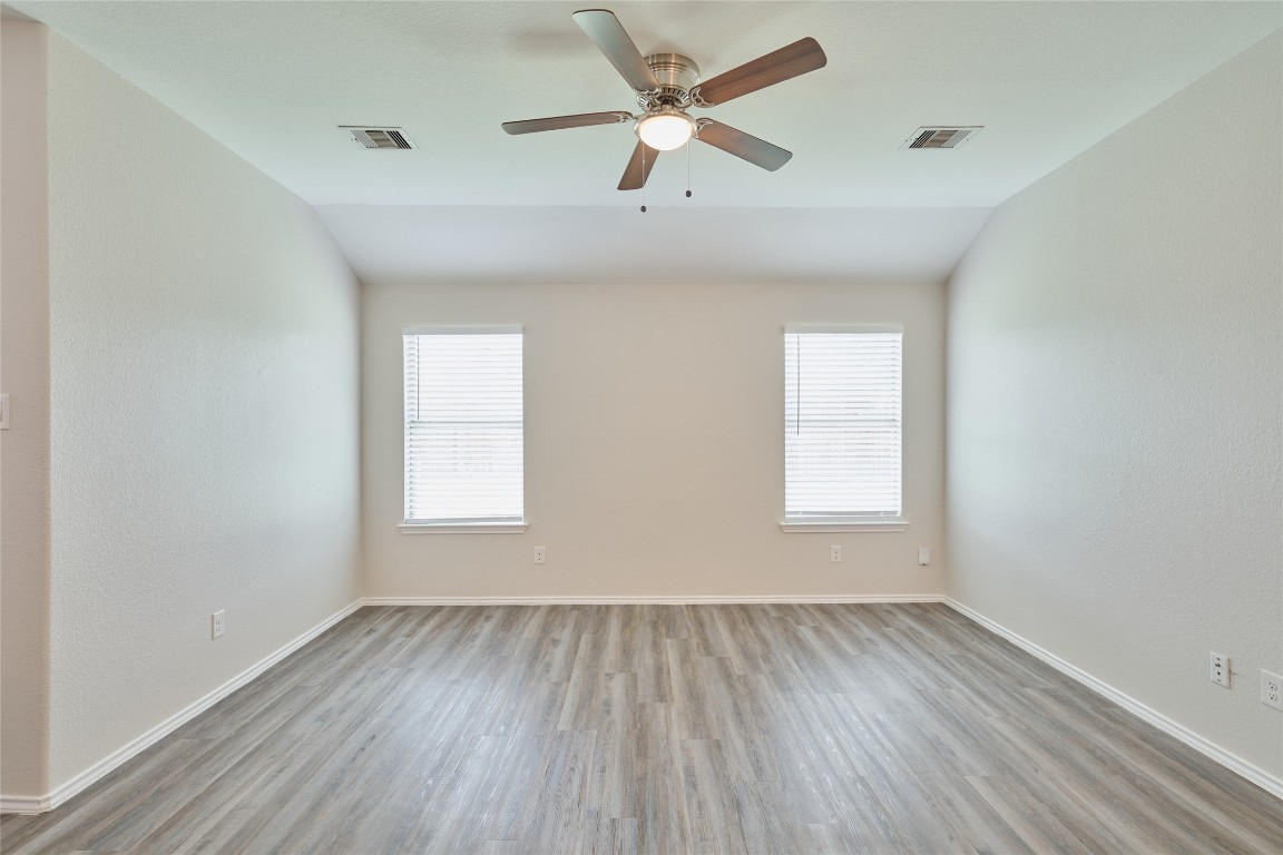 24439 Raindrop Poppy Drive Spring, TX 77373 - Photo 14 of 27 an empty room with a window and wooden floor