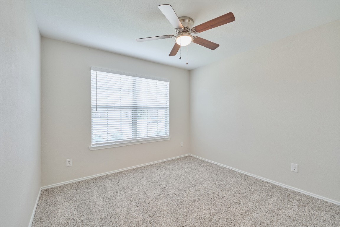 24439 Raindrop Poppy Drive Spring, TX 77373 - Photo 18 of 27 an empty room with a window and a fan