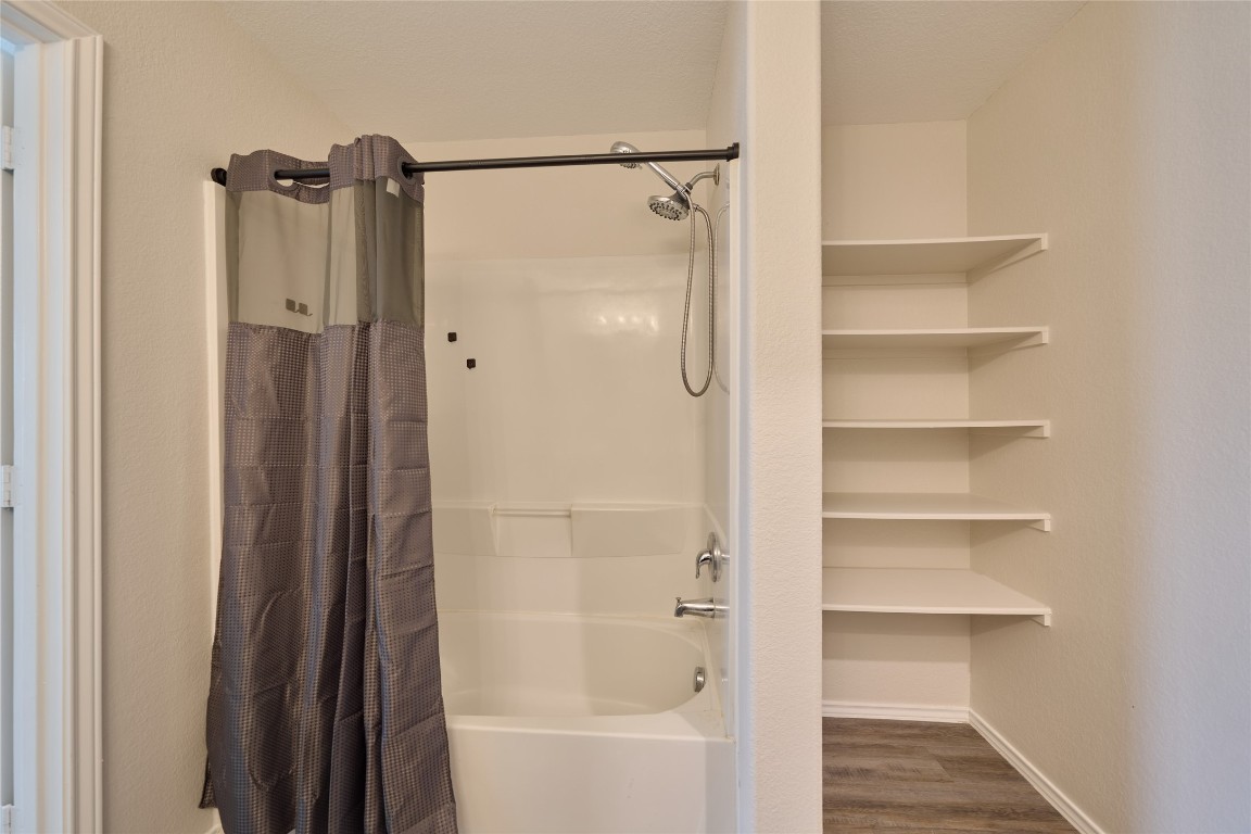24439 Raindrop Poppy Drive Spring, TX 77373 - Photo 21 of 27 a bathroom with a shower and a glass door