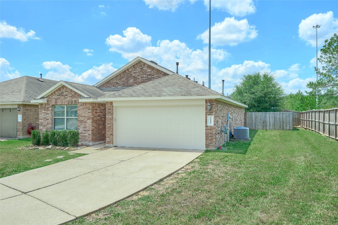 24439 Raindrop Poppy Drive Spring, TX 77373 - Photo 3 of 27 a front view of a house with garden