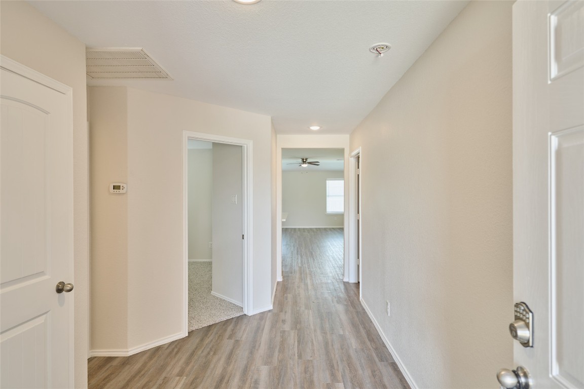 24439 Raindrop Poppy Drive Spring, TX 77373 - Photo 6 of 27 a view of a hallway with wooden floor
