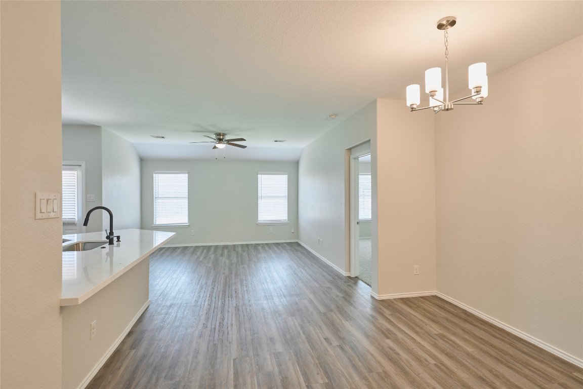 24439 Raindrop Poppy Drive Spring, TX 77373 - Photo 8 of 27 a very nice looking room with wooden floor and chandelier