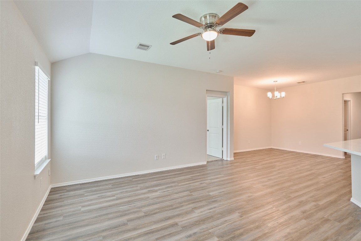 24439 Raindrop Poppy Drive Spring, TX 77373 - Photo 10 of 27 an empty room with wooden floor and a ceiling fan
