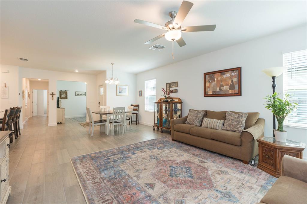 10806 Gable Dig Loop San Antonio, FL 33576 - Photo 11 of 73 a living room with furniture and a chandelier