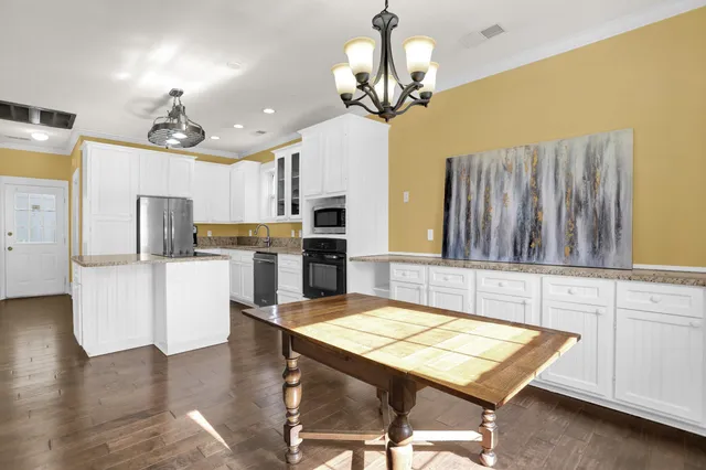 a view of a dining room with furniture and chandelier