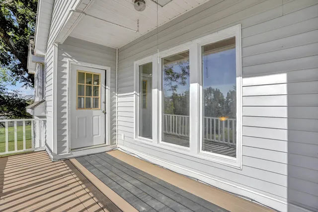 a spacious bedroom with a bed and a chandelier