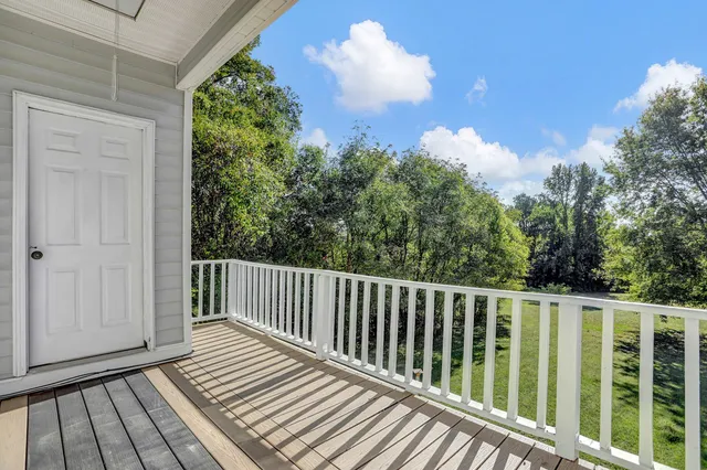 a view of a house with a door and wooden floor