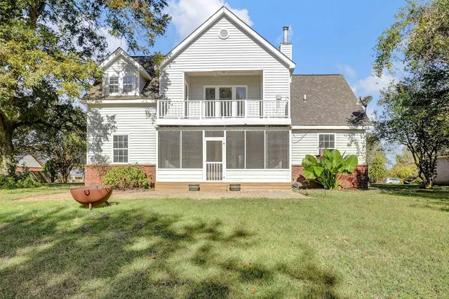 a view of a house with a yard and sitting area