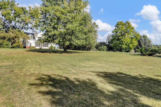 a front view of a house with a garden and plants