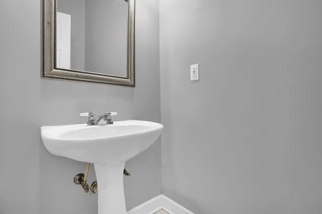 a bathroom with a sink a mirror and a toilet