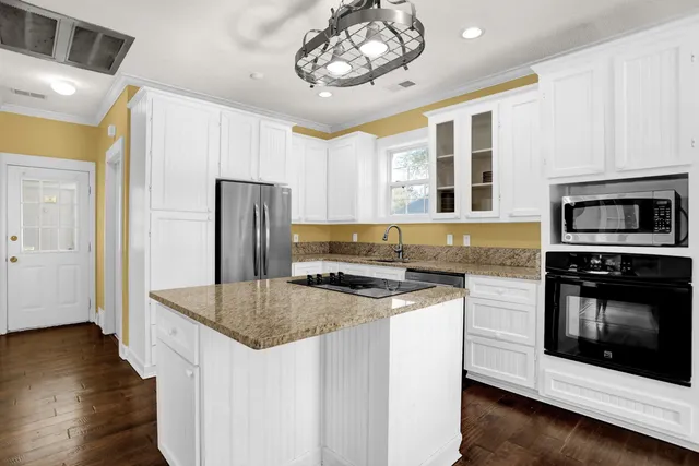 a kitchen with stainless steel appliances granite countertop a stove and a refrigerator