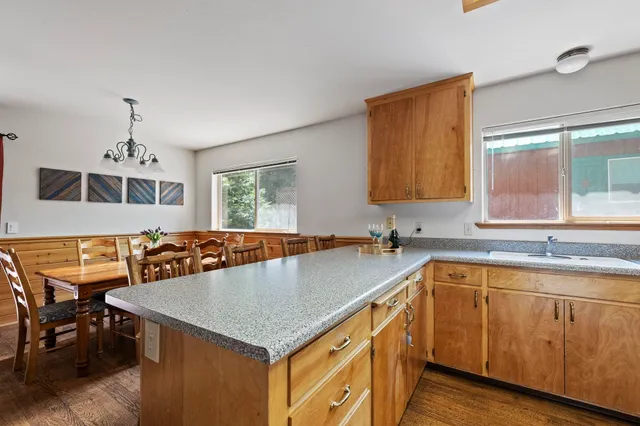 a kitchen with stainless steel appliances a sink dishwasher stove refrigerator and microwave
