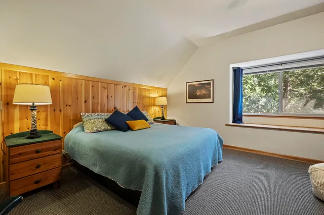 a bedroom with bed and a window