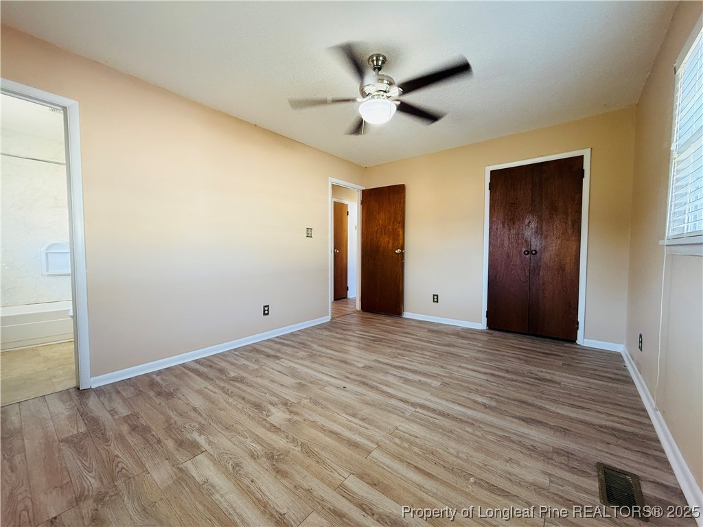 611 Reggie Court Spring Lake, NC 28390 - Photo 13 of 20 a view of an empty room and wooden floor