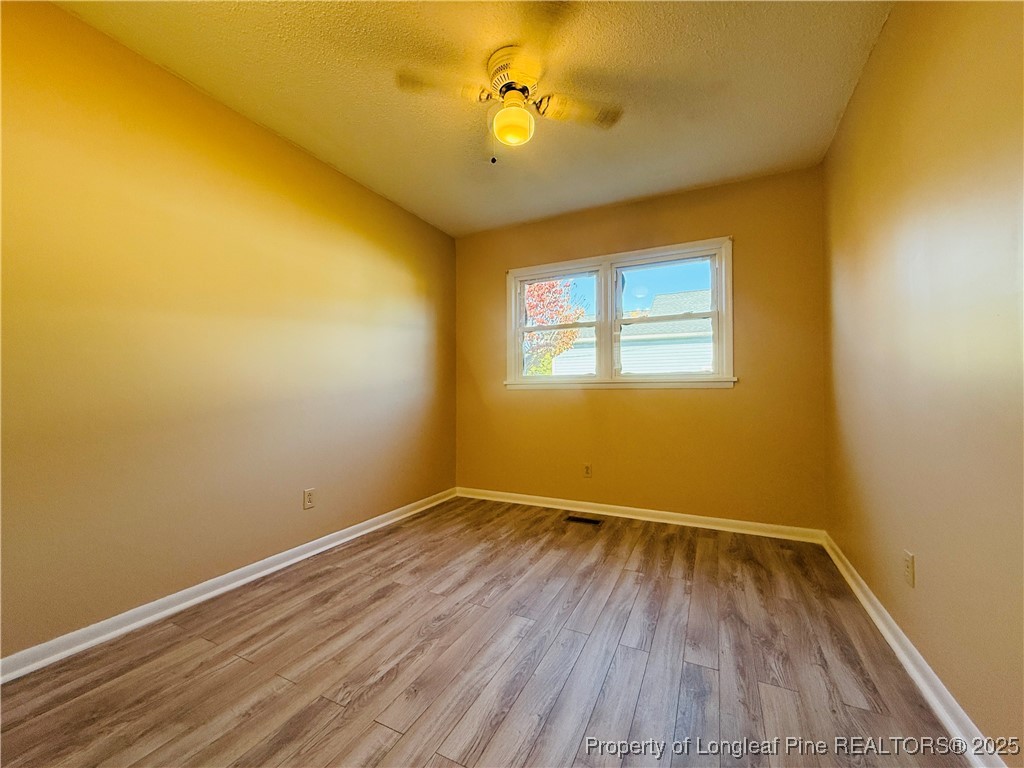 611 Reggie Court Spring Lake, NC 28390 - Photo 15 of 20 a view of room with wooden floor and fan