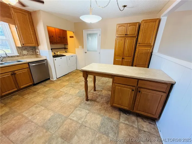 a room with furniture a flat screen tv and a refrigerator