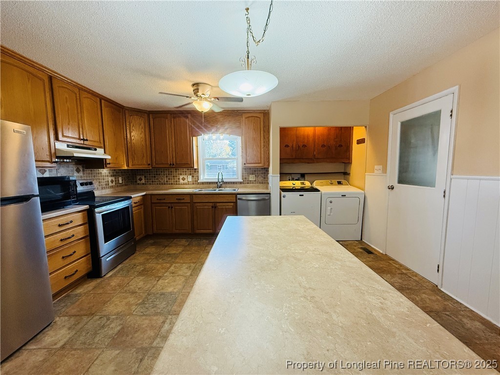 611 Reggie Court Spring Lake, NC 28390 - Photo 8 of 20 a kitchen with stainless steel appliances granite countertop a stove top oven a sink dishwasher and a refrigerator with wooden floor