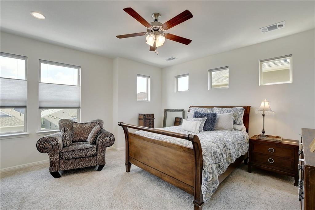 228 Simon Kyle, TX 78640 - Photo 17 of 35 Bedroom with ceiling fan and light carpet