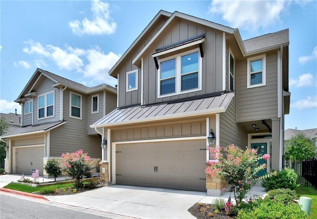 228 Simon Kyle, TX 78640 - Photo 2 of 35 Craftsman house with board and batten siding, a garage, a standing seam roof, and driveway