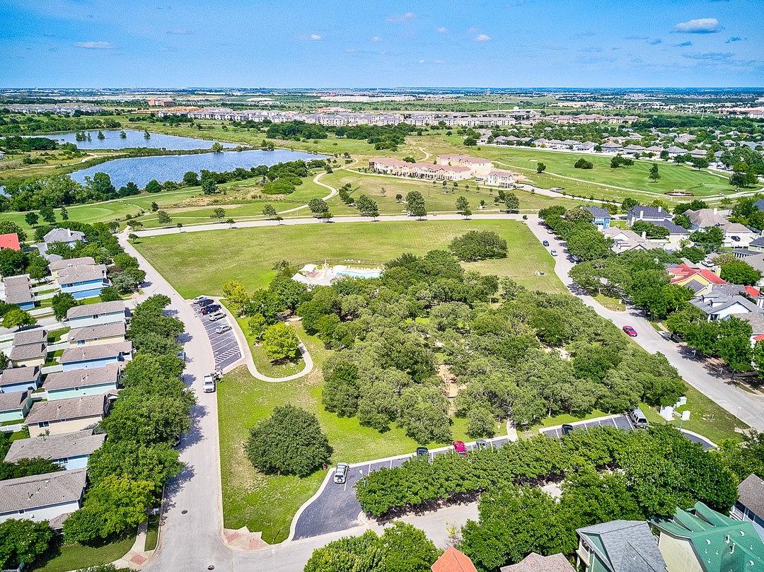 228 Simon Kyle, TX 78640 - Photo 31 of 35 Aerial view of residential area with a nearby body of water