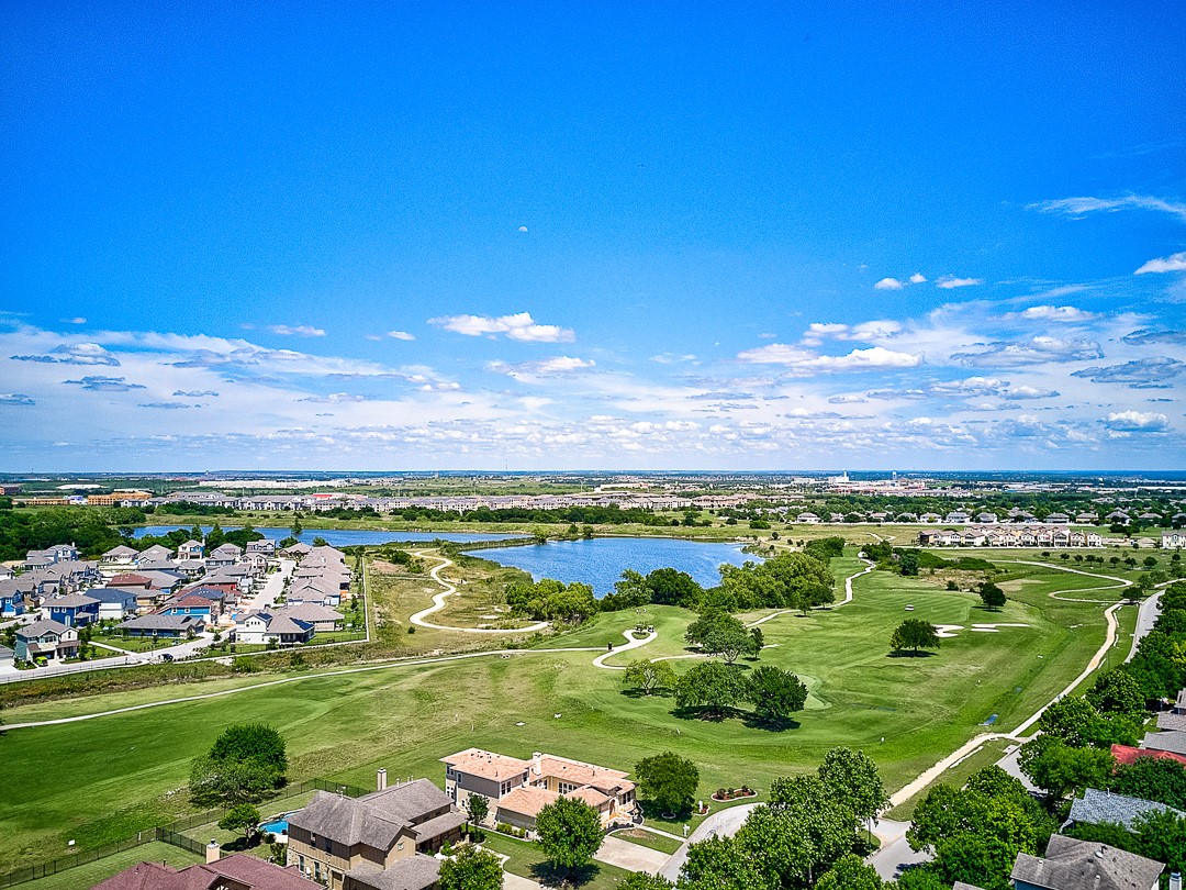 228 Simon Kyle, TX 78640 - Photo 35 of 35 Aerial perspective of suburban area featuring a nearby body of water and a golf course