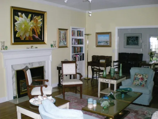 a living room with furniture a fireplace and a flat screen tv