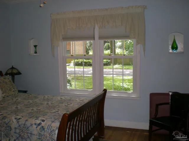 a bathroom with a granite countertop sink and a window