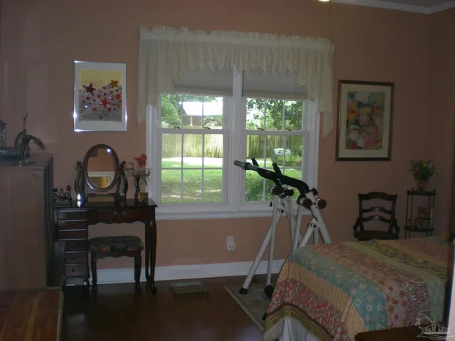 a room with a desk chair and bed