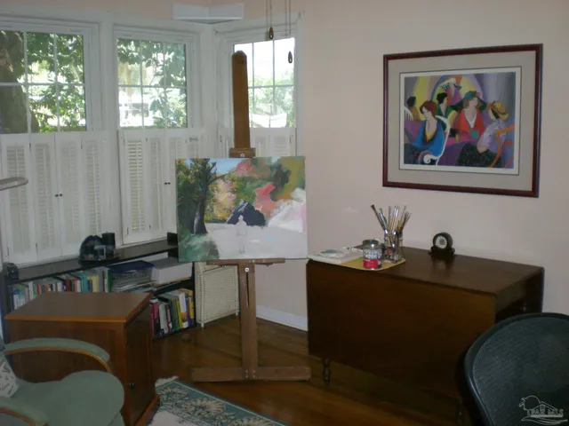 a view of a workspace with furniture and window