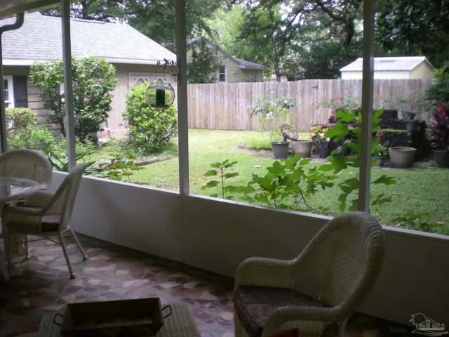 a view of a porch with furniture and garden