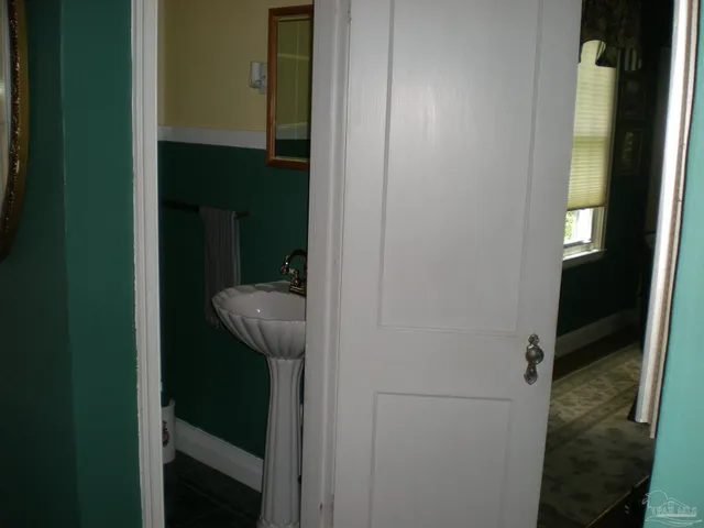 a view of a bathroom from a corridor