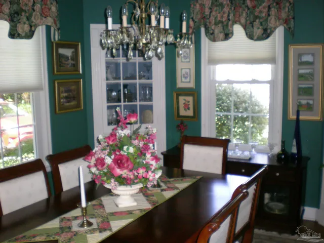a view of a dining room with furniture and window