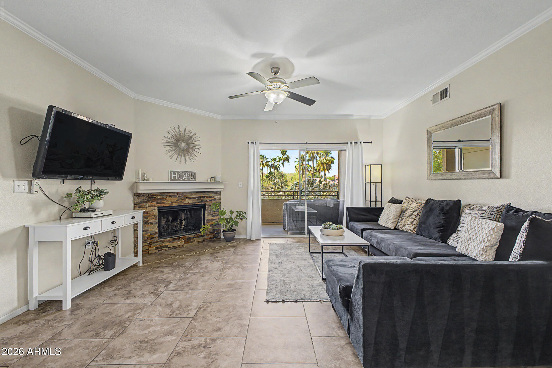 5401 East Van Buren Street, Unit 3017 Phoenix, AZ 85008 - Photo 1 of 37 a living room with furniture fireplace and flat screen tv