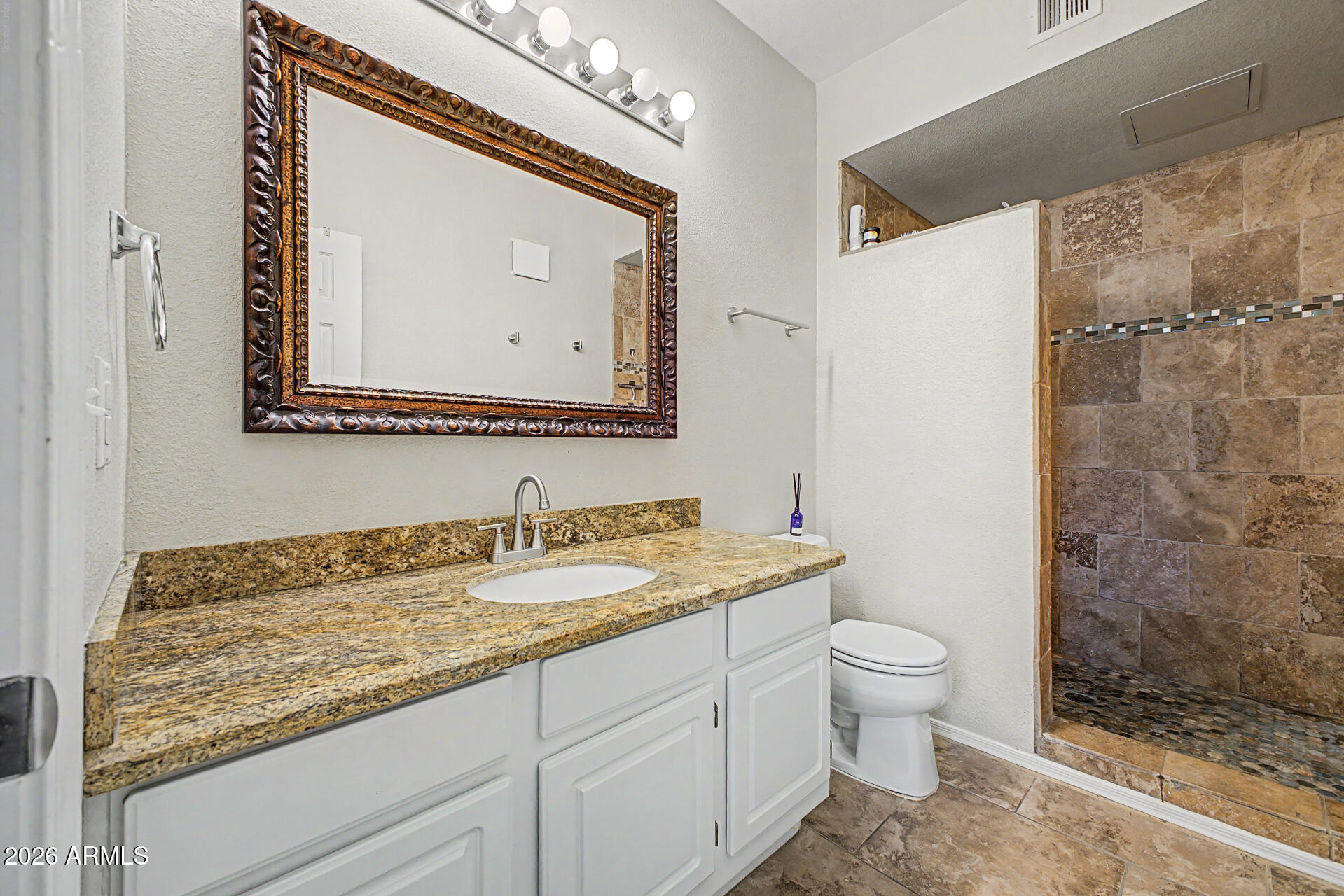 5401 East Van Buren Street, Unit 3017 Phoenix, AZ 85008 - Photo 12 of 37 a bathroom with a granite countertop sink mirror vanity and toilet