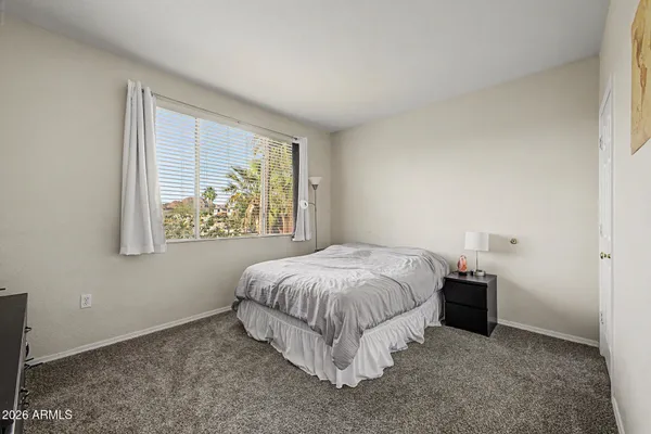 a bed sitting in a bedroom next to a window