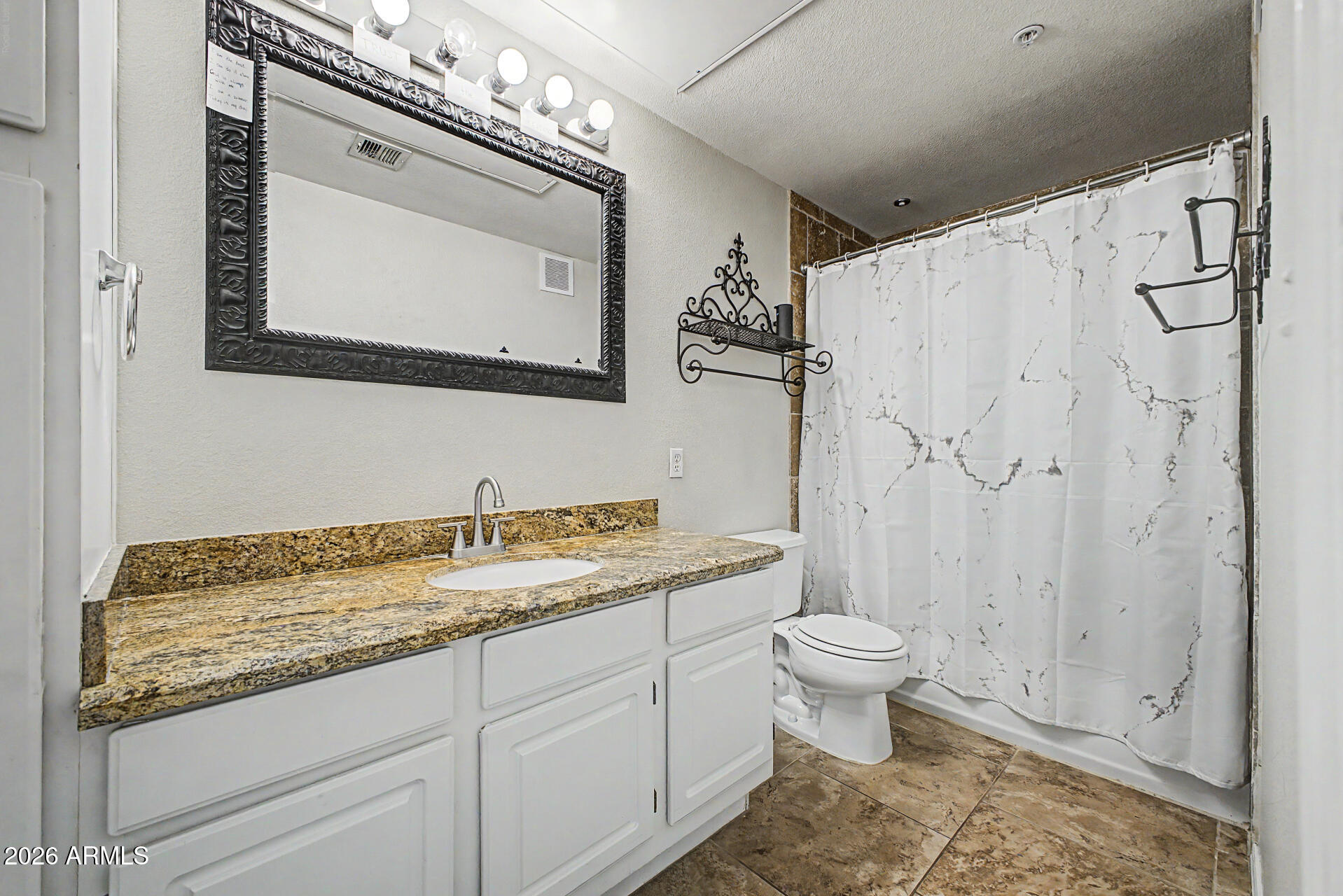 5401 East Van Buren Street, Unit 3017 Phoenix, AZ 85008 - Photo 15 of 37 a bathroom with a granite countertop sink a toilet and a mirror