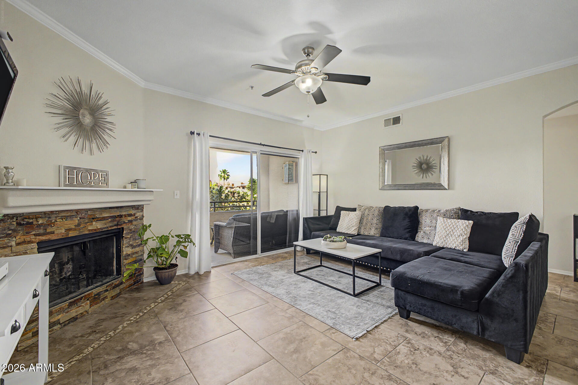 5401 East Van Buren Street, Unit 3017 Phoenix, AZ 85008 - Photo 3 of 37 a living room with furniture and a fireplace