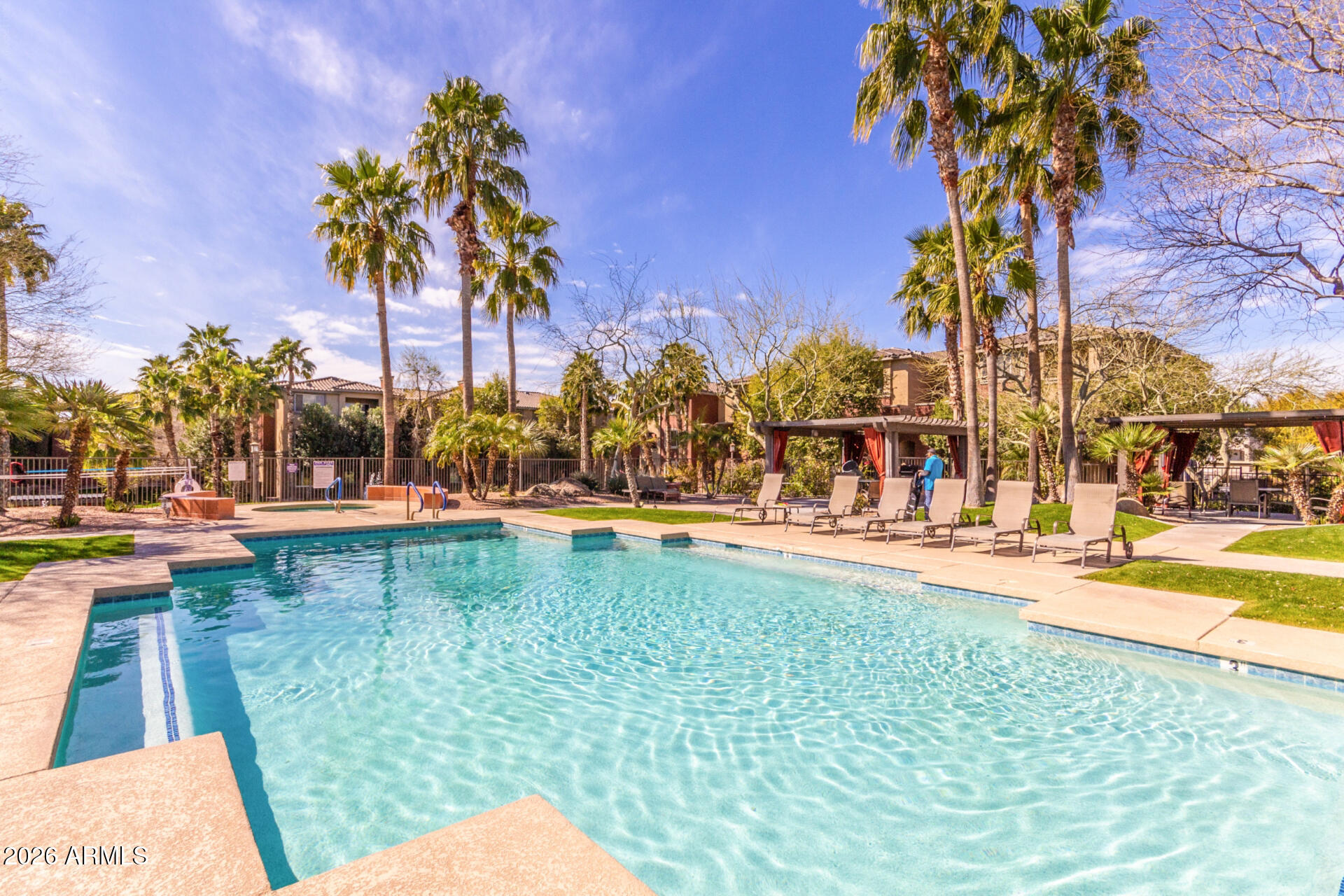 5401 East Van Buren Street, Unit 3017 Phoenix, AZ 85008 - Photo 32 of 37 a view of swimming pool with outdoor seating and trees in the background