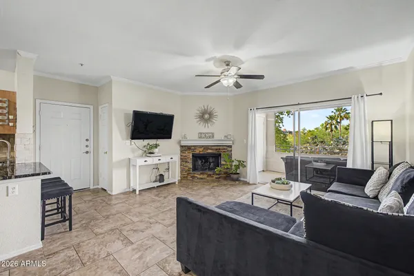 a living room with fireplace furniture and a flat screen tv