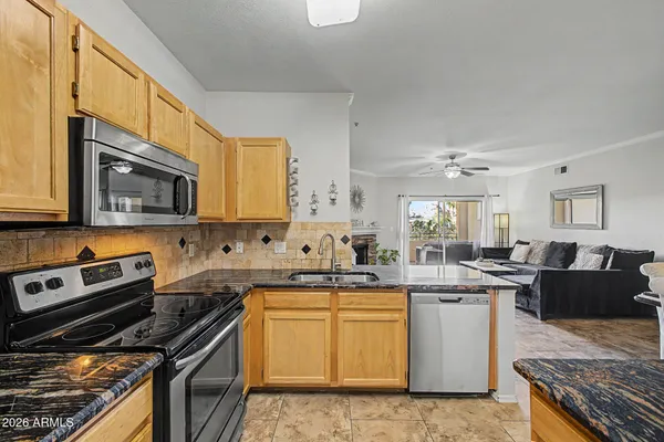 a kitchen with lots of counter top space sink and stainless steel appliances
