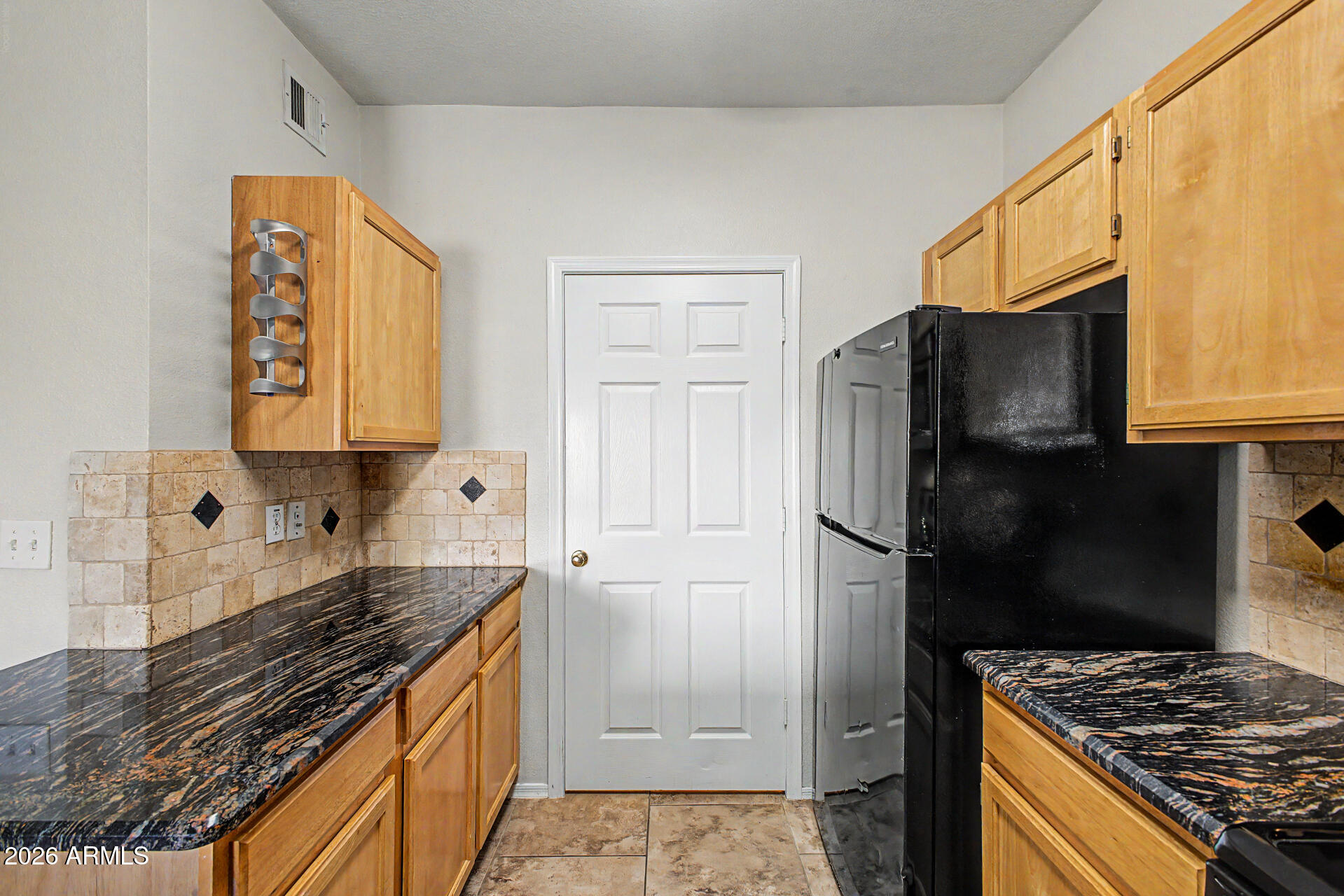 5401 East Van Buren Street, Unit 3017 Phoenix, AZ 85008 - Photo 9 of 37 a kitchen with stainless steel appliances granite countertop a refrigerator and a stove