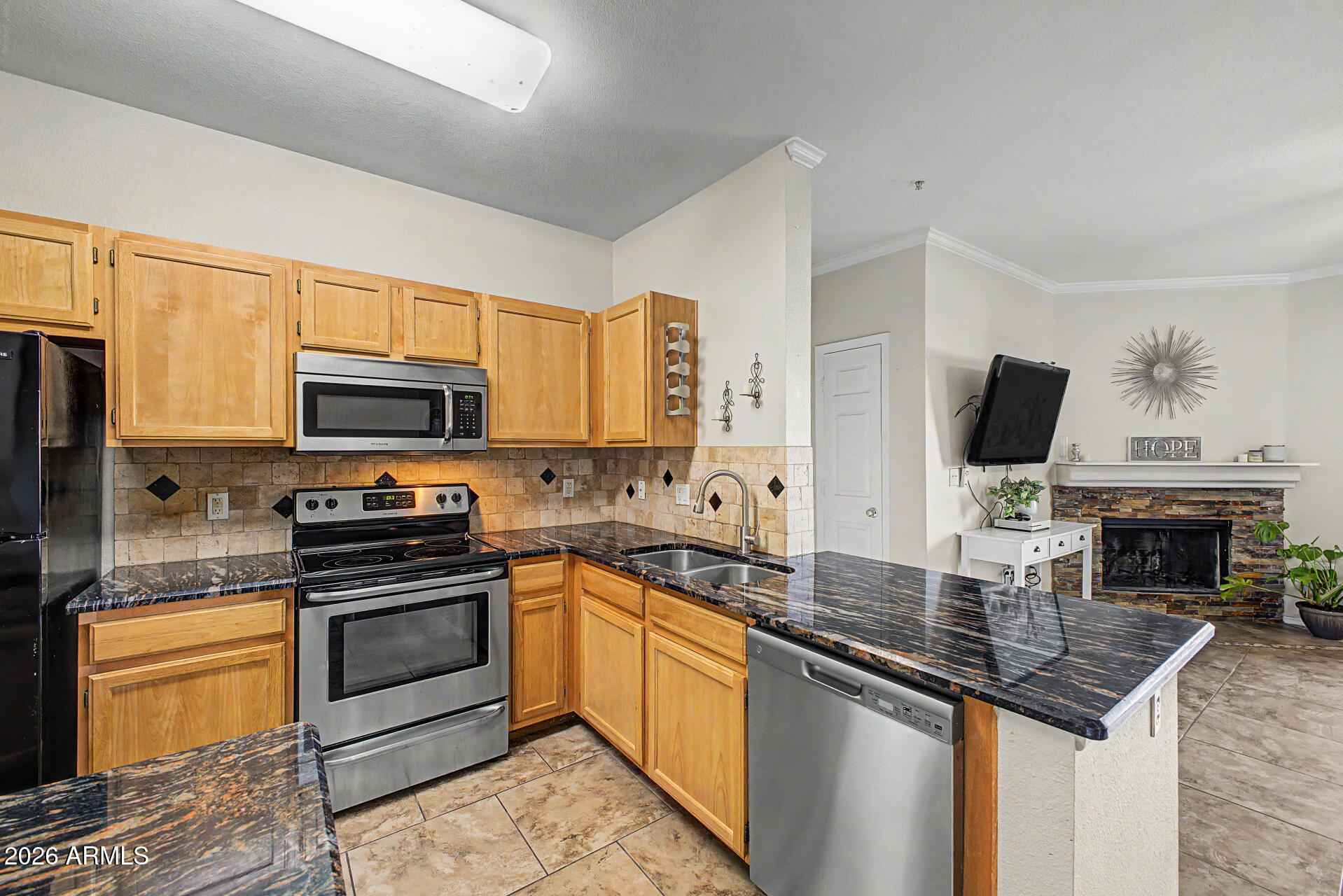 5401 East Van Buren Street, Unit 3017 Phoenix, AZ 85008 - Photo 10 of 37 a kitchen with stainless steel appliances a stove sink microwave and cabinets