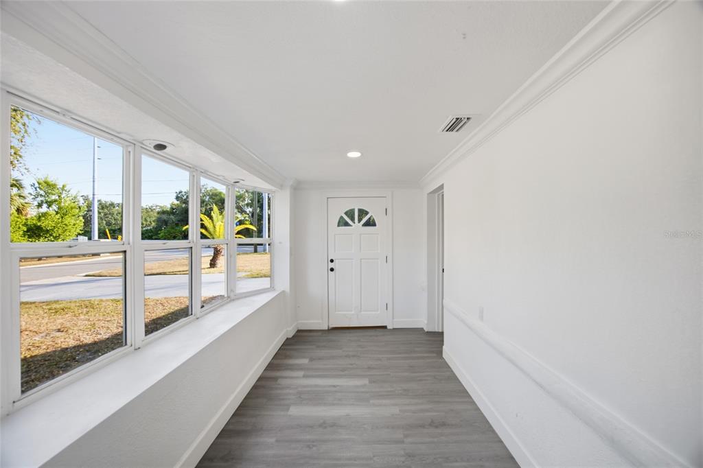 1908 Macomber Avenue Clearwater, FL 33755 - Photo 6 of 24 a view of hallway with wooden floor and windows