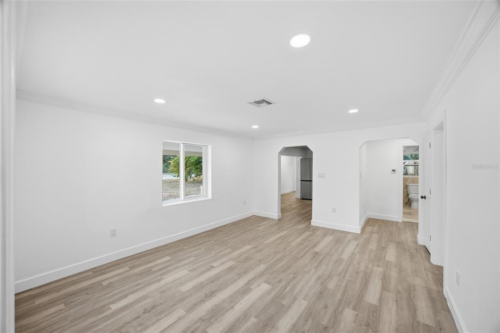 1908 Macomber Avenue Clearwater, FL 33755 - Photo 9 of 24 a view of an empty room with wooden floor and a window