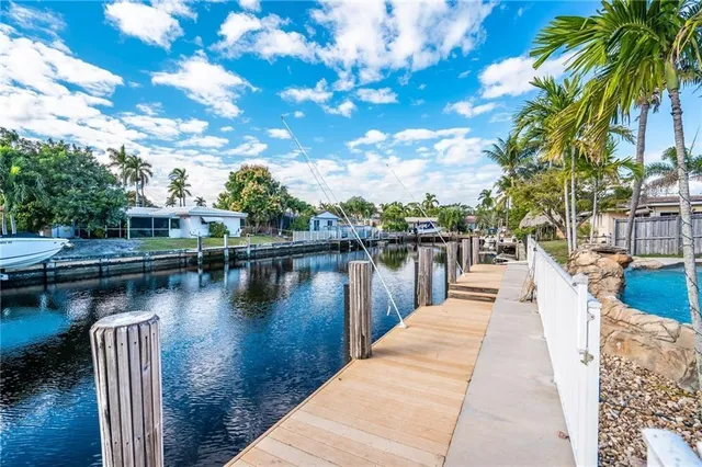 a view of a lake with boats and palm trees