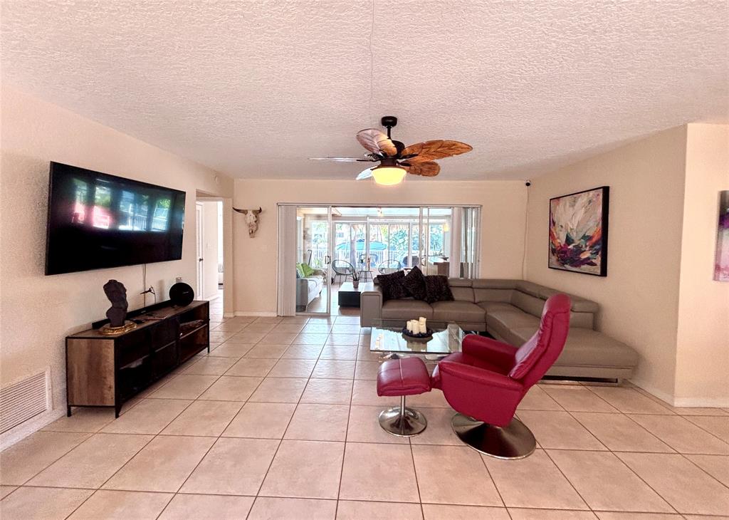 5911 Northeast 15th Avenue Fort Lauderdale, FL 33334 - Photo 18 of 21 a living room with furniture and a flat screen tv