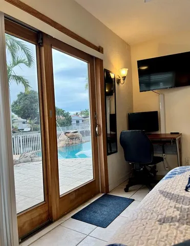 a view of a workspace with furniture and a window